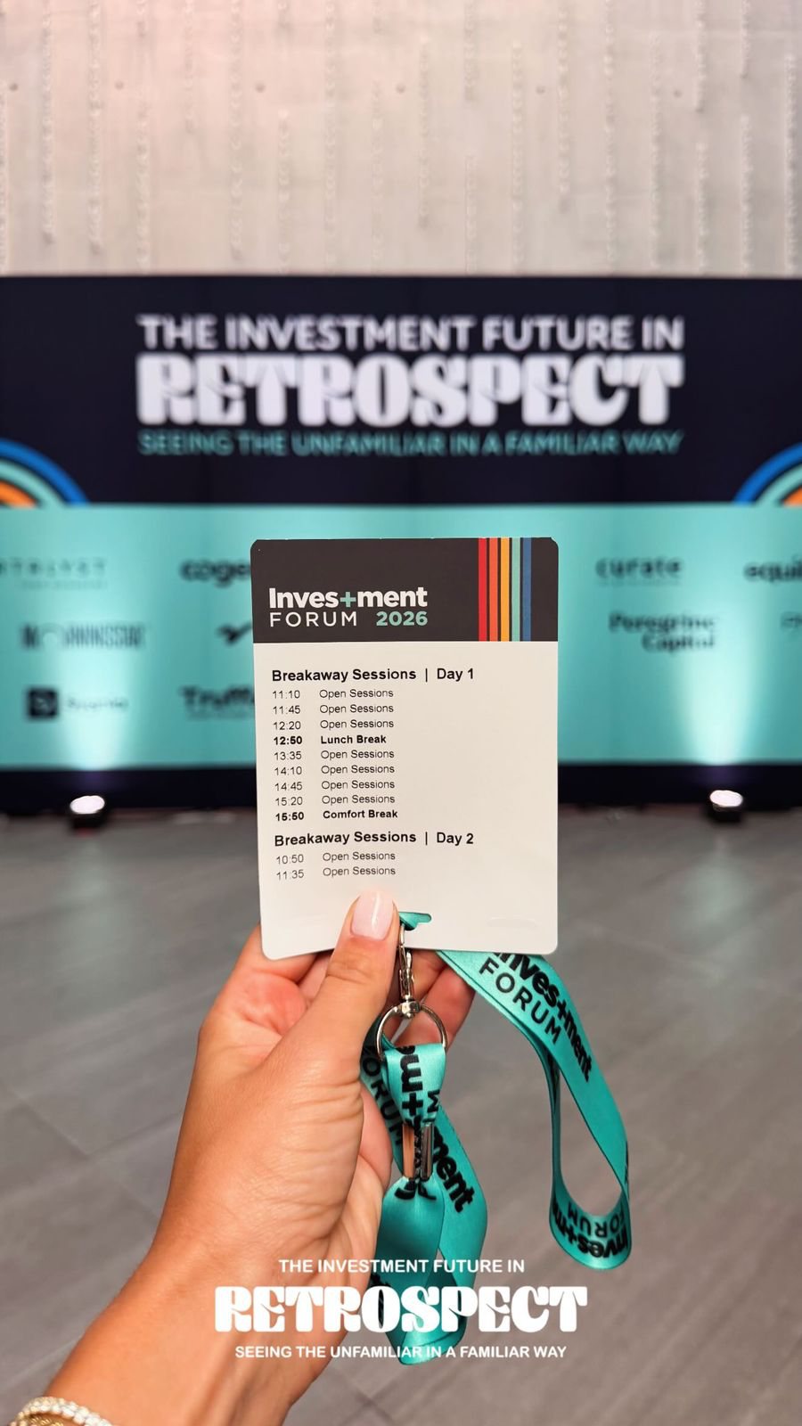 A guest holding a paper event badge showing the breakaway session schedule