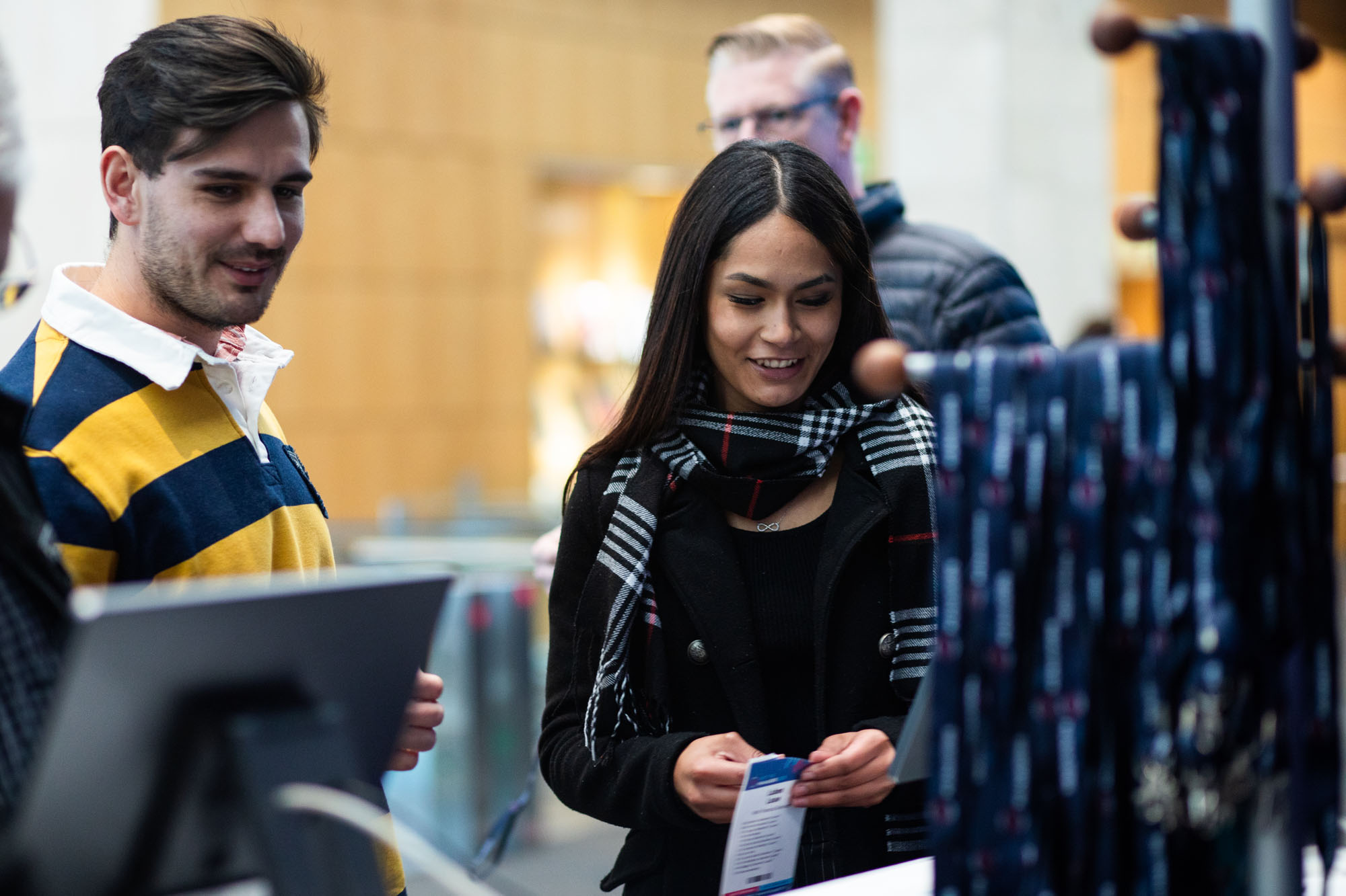 A guest collecting a freshly printed name badge at a GEL Events welcome desk