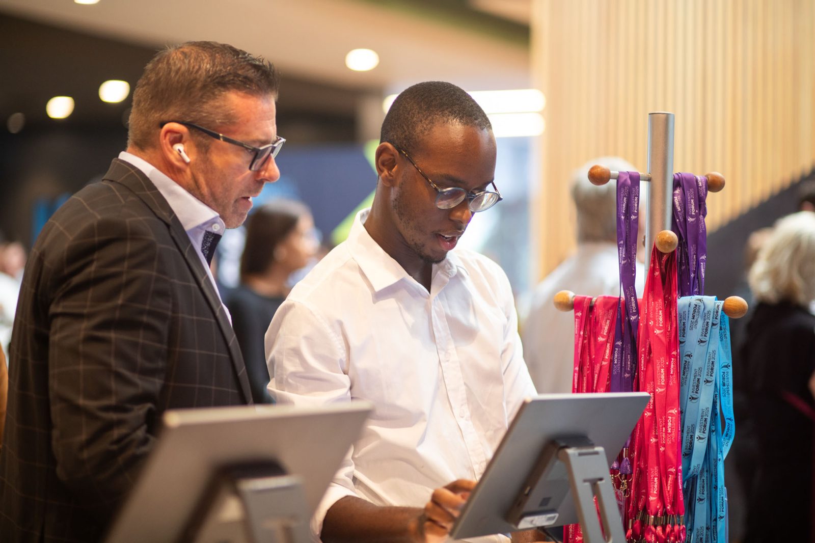A GEL team member assisting a guest at a check-in kiosk