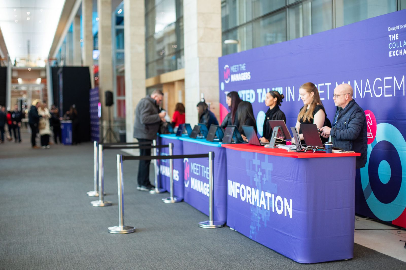 A staffed information and registration desk at an asset management event