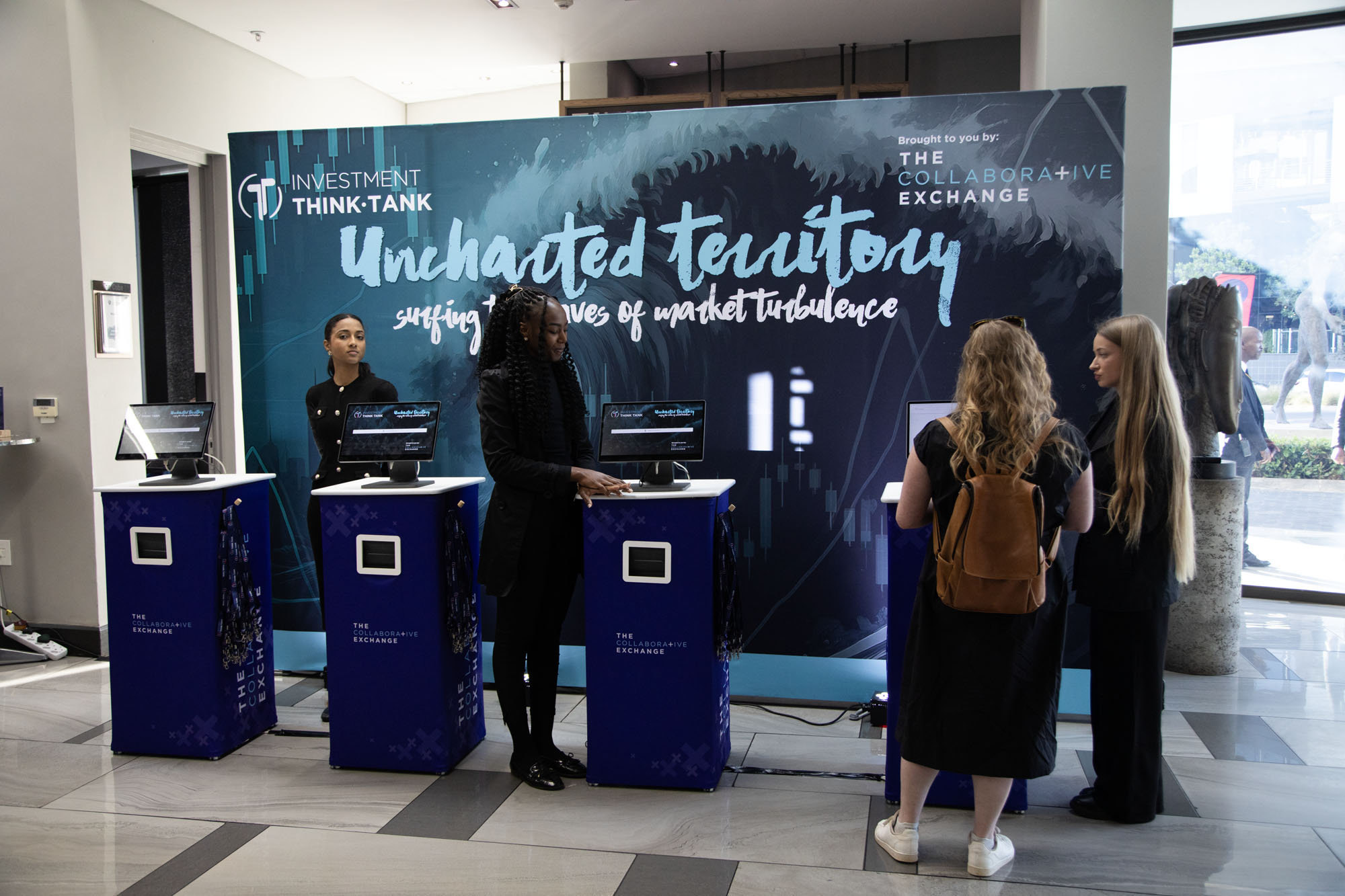 Guests checking in at branded GEL kiosks at the Investment Think-Tank